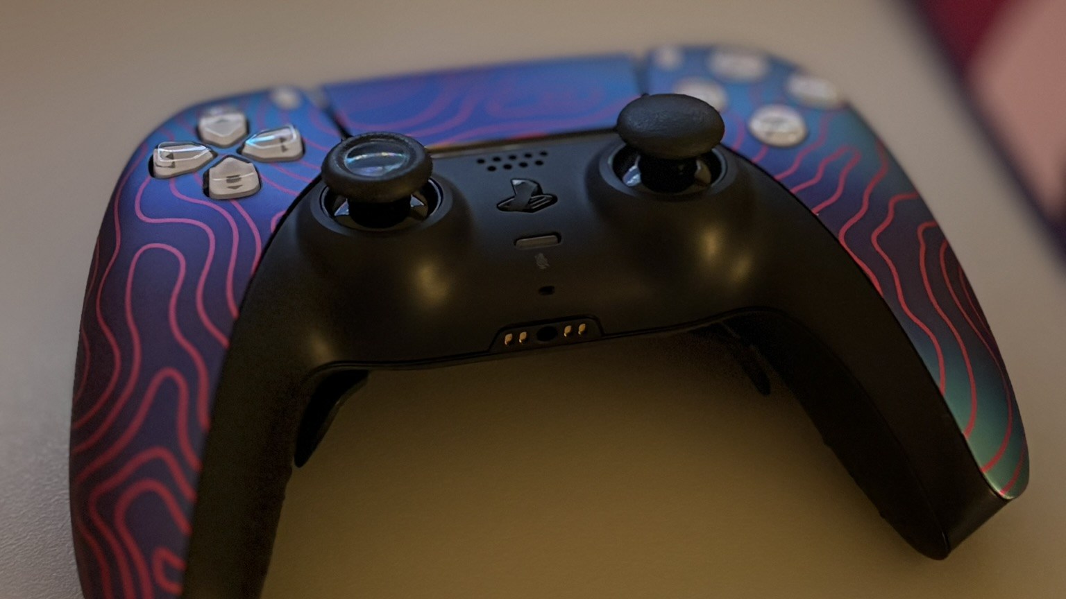 Modded PS5 controller with paddles and a Damascus-style swirl, built by FTW Gaming